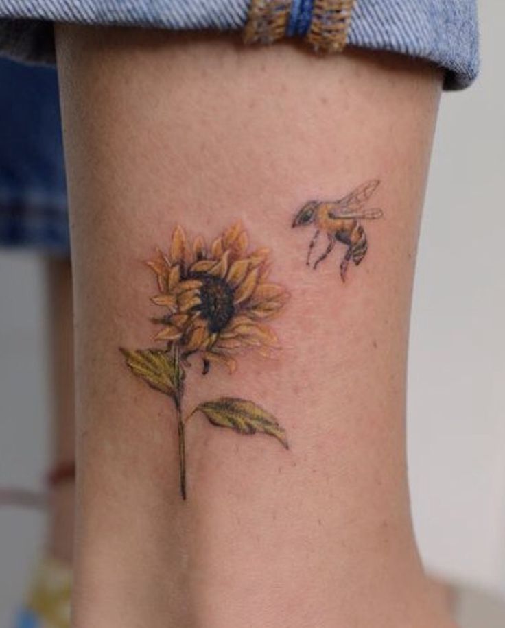 a small sunflower with a bee on it's back side ribcage