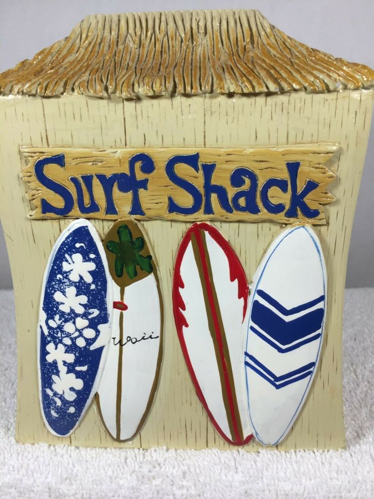 a surf shack with three surfboards painted on it