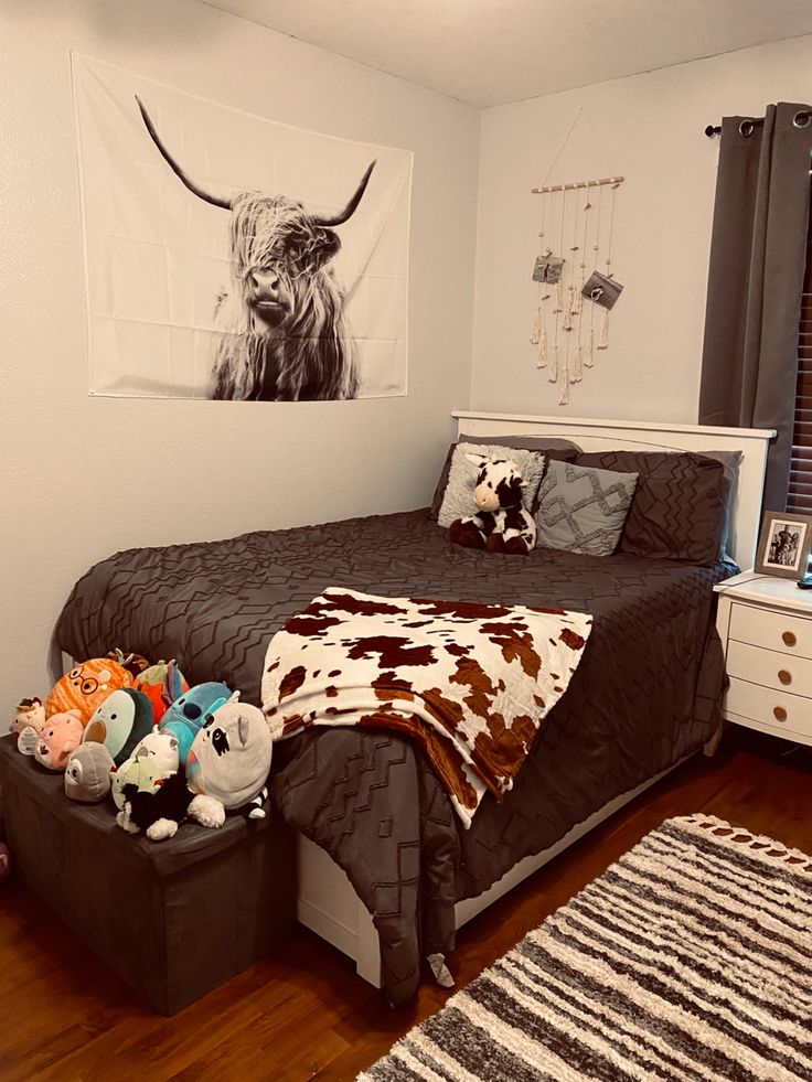 a room with a bed, dresser and pictures on the wall above it is decorated in black and white