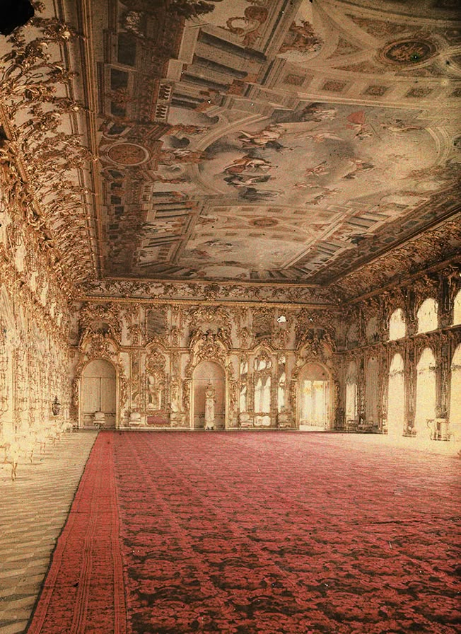 an ornately decorated room with red carpet