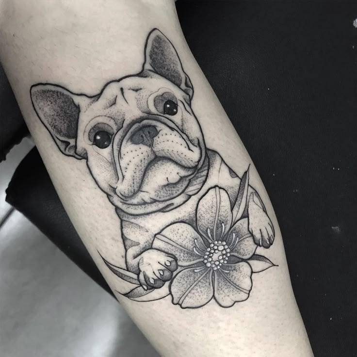 a black and white photo of a dog with flowers on it's leg,