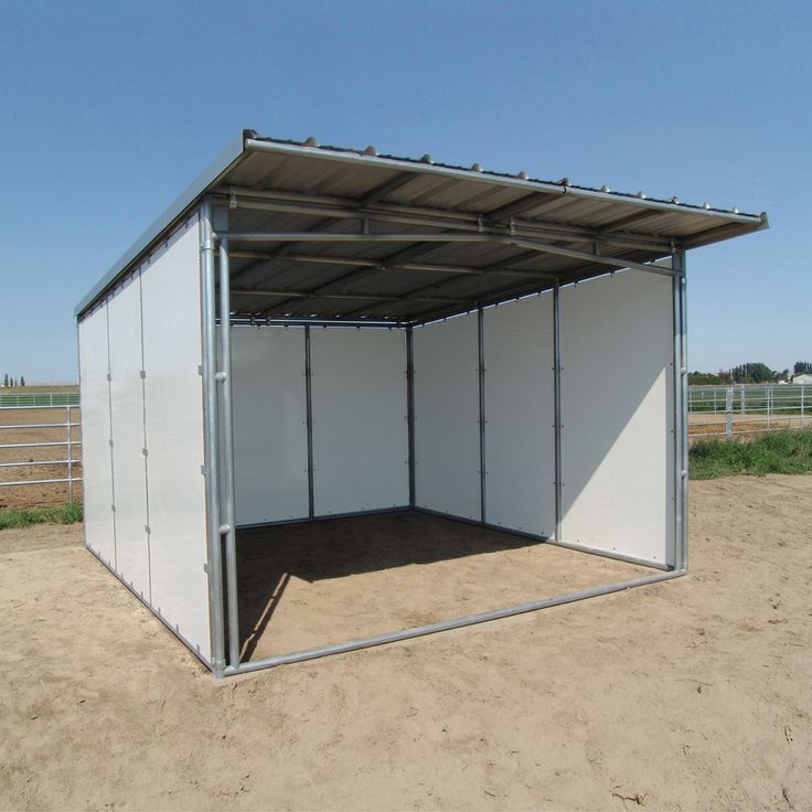 an enclosed area in the middle of a dirt field