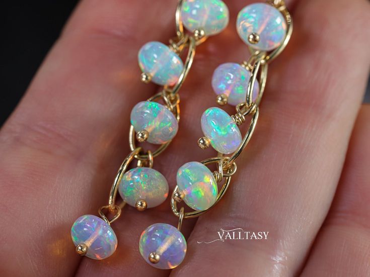 "On the Edge Earrings - Solid Gold 14K Ethiopian Opal Dangle Earrings, Ethiopian Welo Opal Earrings in 14K Gold These absolutely amazing floating Ethiopian Opals dangle on a statement SOLID GOLD 14K chain, each hoop creates a glowing gold halo around the Opal. You've never seen such Opals before! I've used the most fantastic, very large Welo Ethiopian Opals: each bead has a fiery splash of color - blues, greens, pinks, purples.... they glow even in darkness! :) These modern earrings will fit any Antique Opal Jewelry, Multicoloured Earrings, Ethiopian Opal Earrings, Ethiopian Opal Jewelry, Fire Opal Earrings, Ethiopian Opal Necklace, Gold Chain Earrings, Aesthetic Jewelry, Sky Full