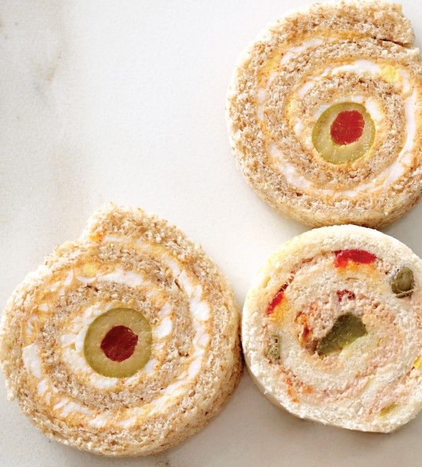 three pastries with different toppings on them sitting on a white counter top next to each other