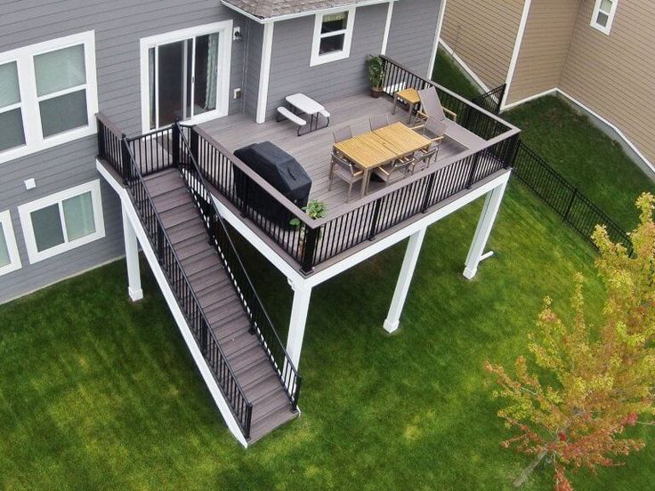 an aerial view of a house with deck and patio