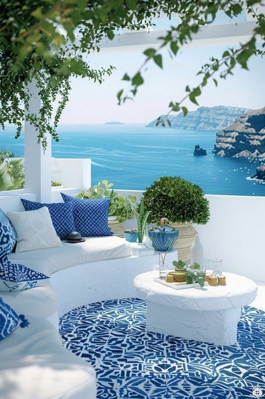 an outdoor living room with blue and white decor