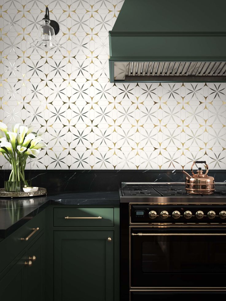 a stove top oven sitting next to a green kitchen counter with white flowers on it