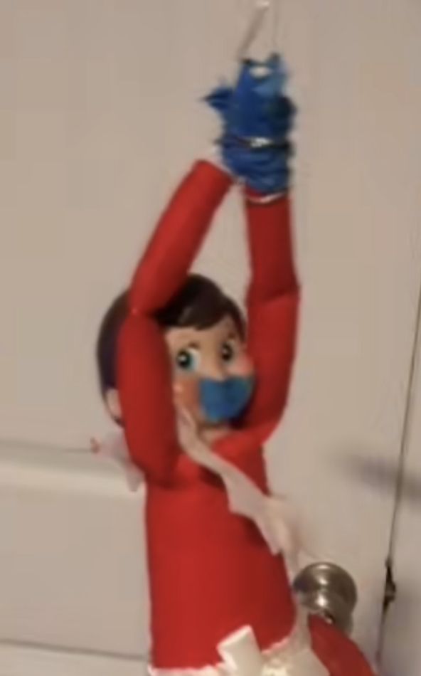 an elf is holding up a water bottle in the air