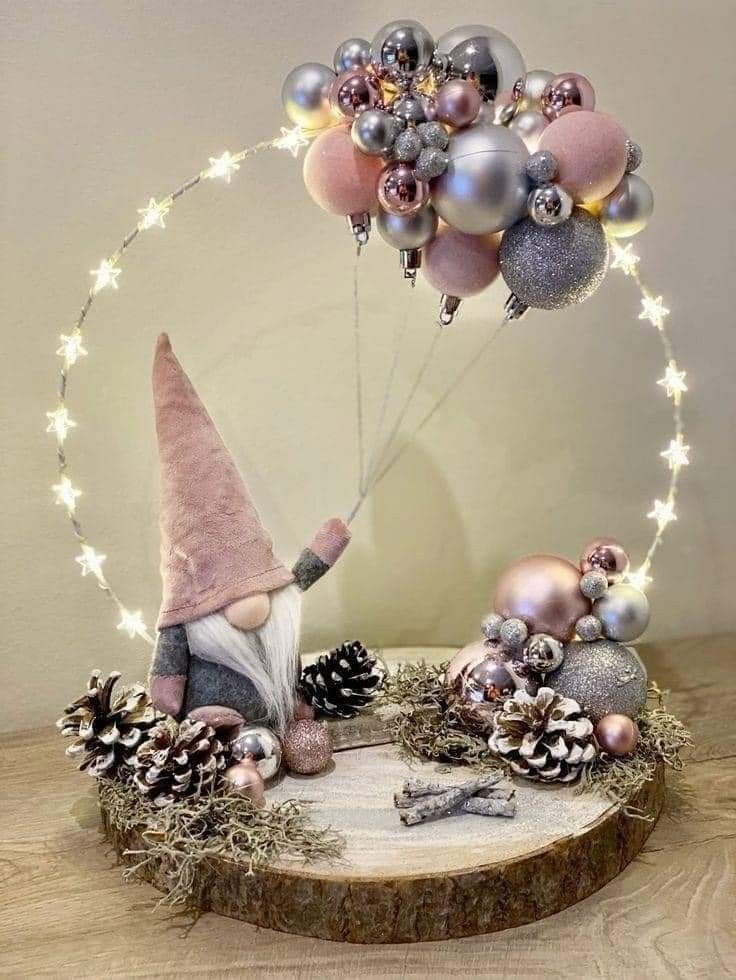 a gnome is holding onto some christmas decorations