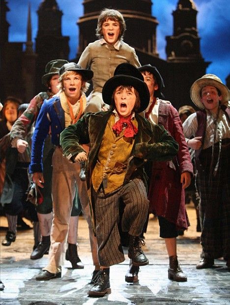 a group of people on stage with one man in top hat and the other holding his mouth open