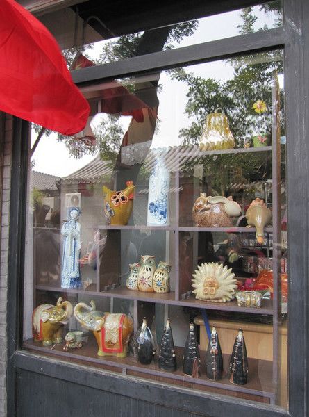 a window display with vases and other items in it