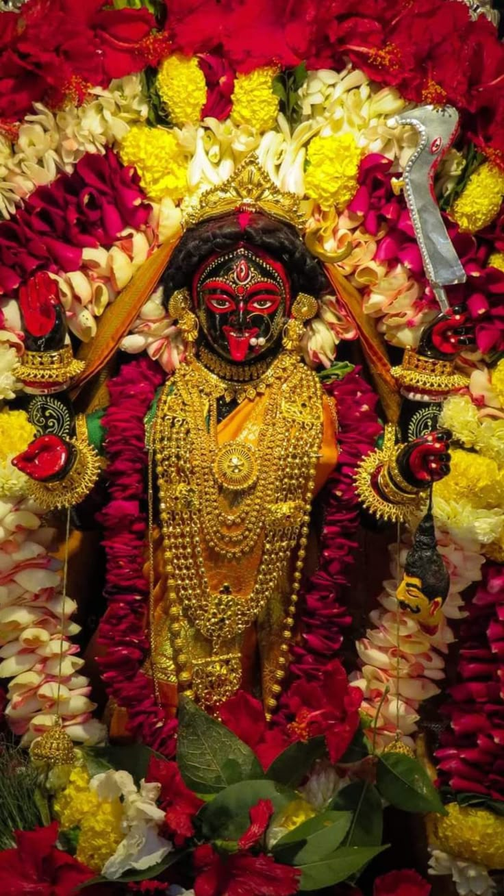 an idol is surrounded by flowers and other decorations