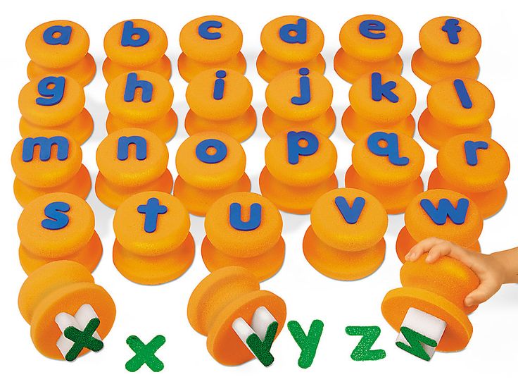 a child is playing with an orange plastic alphabet set and matching letters to spell it