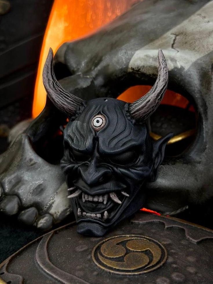 a black mask with horns on top of a table