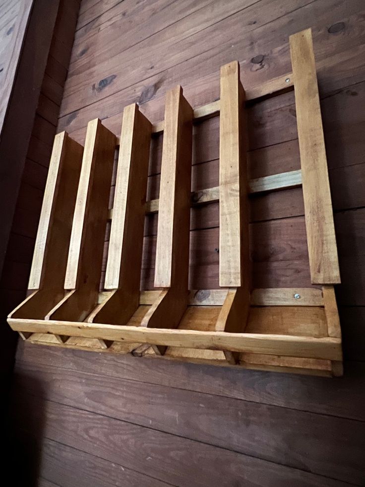 a wooden shelf with four different sized shelves on it