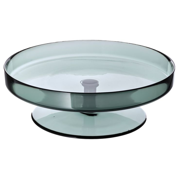 a glass cake plate on a white background with a black rim and bottom part in the shape of a bowl