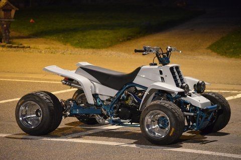 a white four - wheeler parked in a parking lot