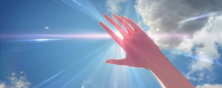 a person's hand reaching up into the sky with bright sun shining through clouds