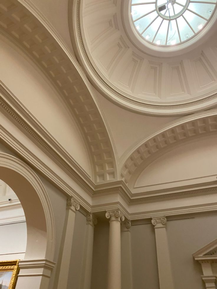 the ceiling is painted white and has a round window