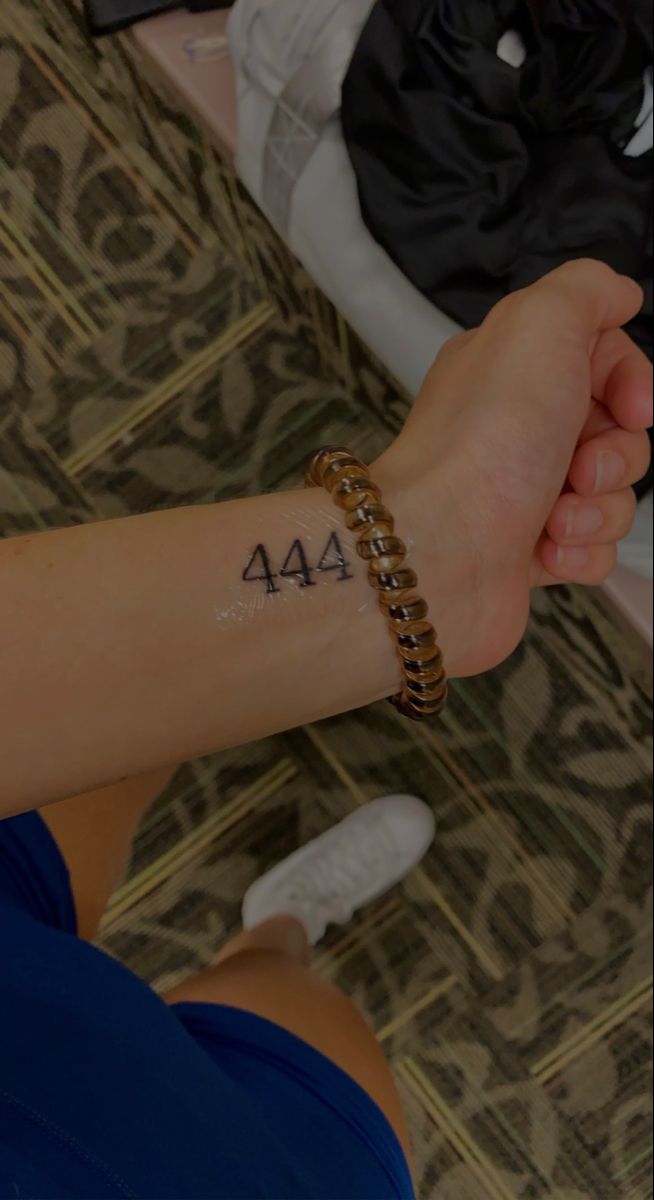 a woman's arm with a tattoo on it and the number forty - four