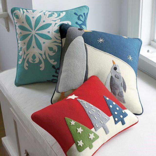 three pillows are sitting on a window sill in front of a snowflake