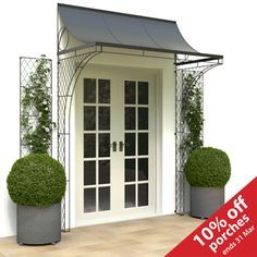 an image of a white front door with potted plants on the side and red sign that says 100 % off