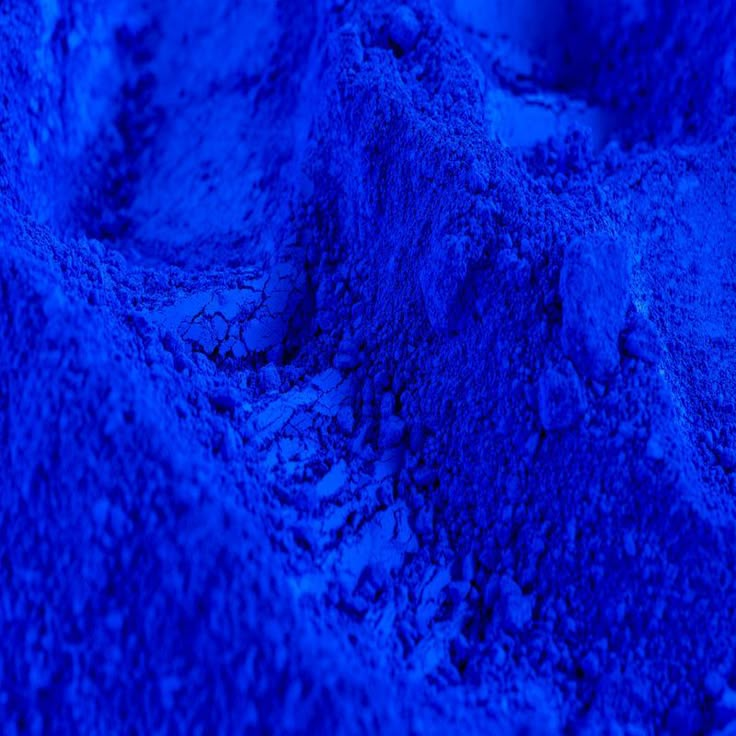 a pile of blue sand sitting on top of a beach