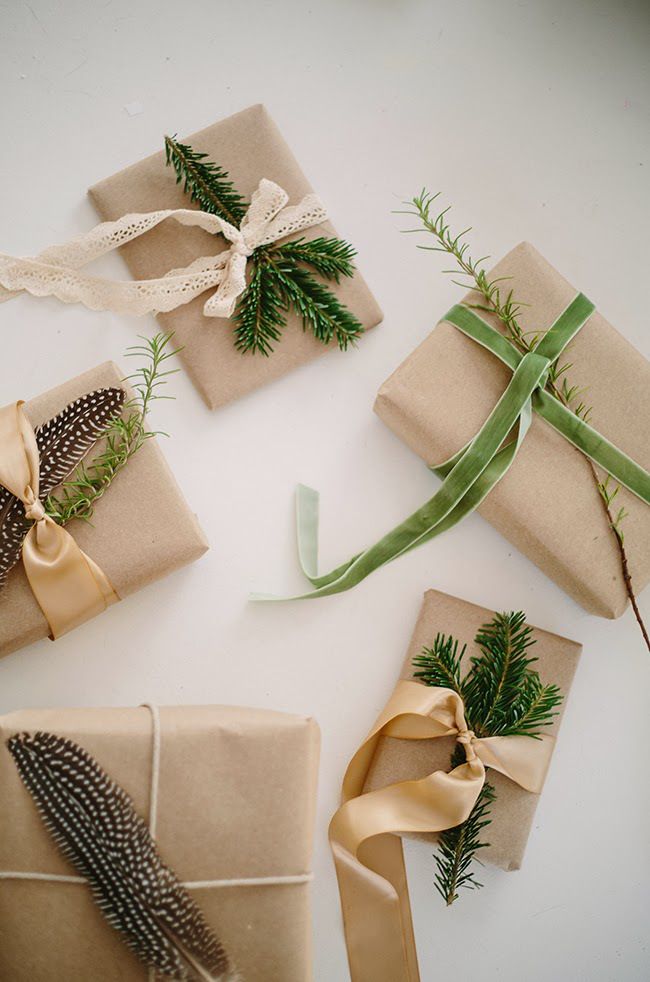 presents wrapped in brown paper and tied with green ribbons, pine cones and evergreen needles