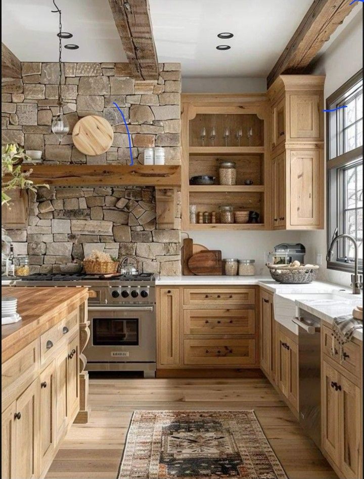 a kitchen with wooden cabinets and stone wall in the backround, along with a rug on the floor