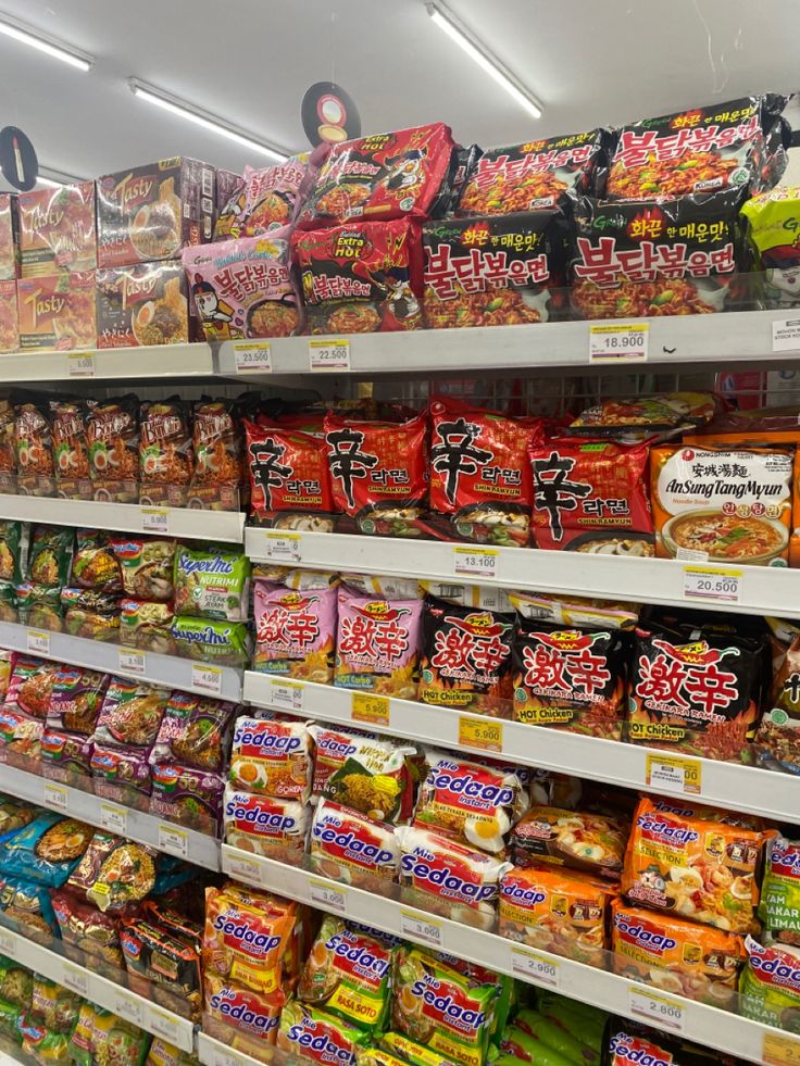 a store shelf filled with lots of different types of snacks and candy bars on display