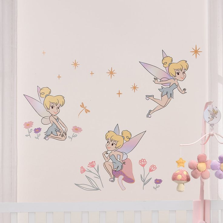 three tinkerbells sitting on top of a wall next to a crib