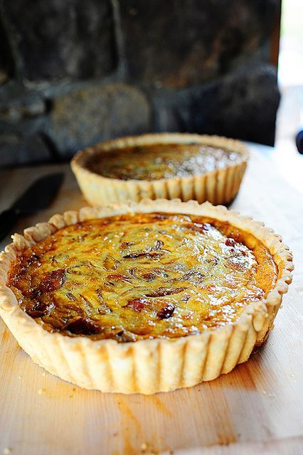 two pies sitting on top of a wooden cutting board