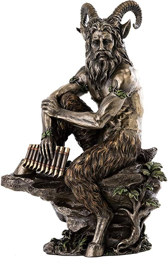 a statue of a man sitting on top of a tree stump holding an instrument in his hands