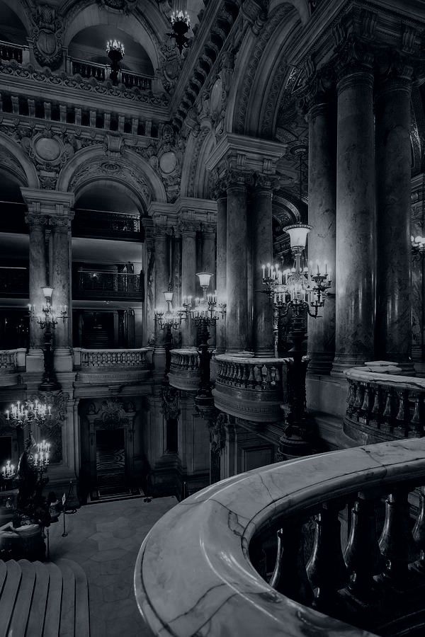 the inside of a building with chandeliers and benches