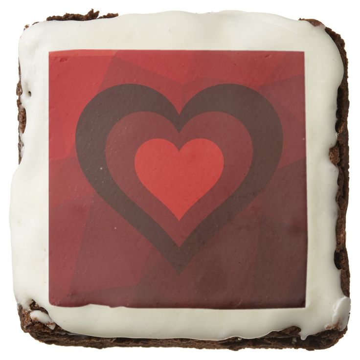 a piece of cake with white frosting and two hearts on it's side