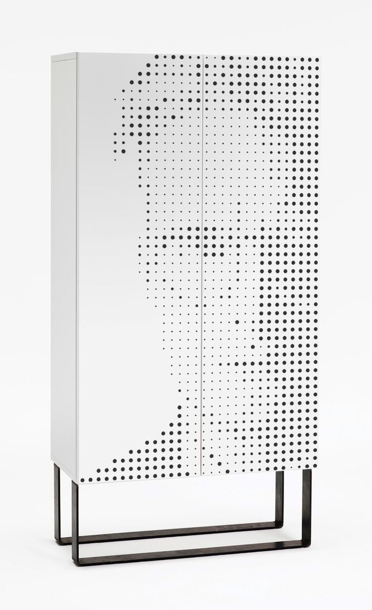 a white cabinet sitting on top of a metal stand with dots all over the front