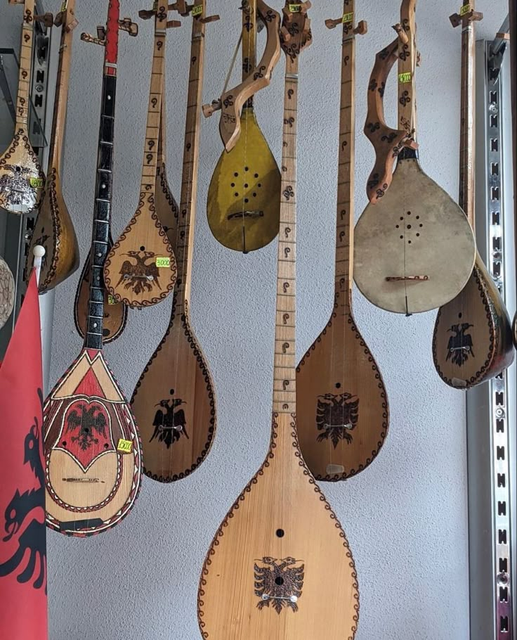 many different types of musical instruments hanging on a wall