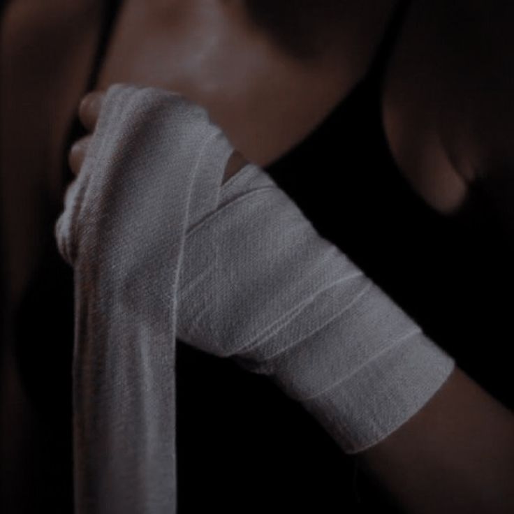 a woman with bandages on her arm