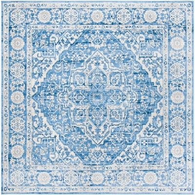 a blue and white rug with an intricate design on the middle, in front of a white background