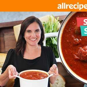 a woman holding a bowl of soup in front of a pot with meatballs on it