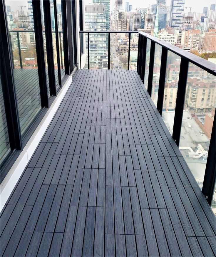 an empty balcony overlooking a city with high rise buildings