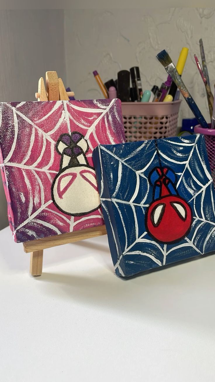 two painted bags sitting on top of a table