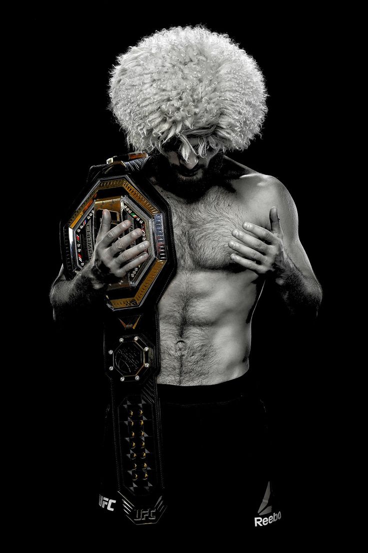 a man with an afro holding a wrestling ring