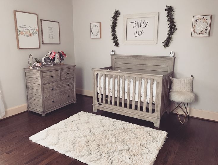 a baby's room with a crib, dresser and bed