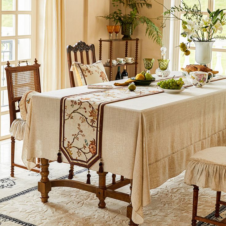 a dining room table set with place settings