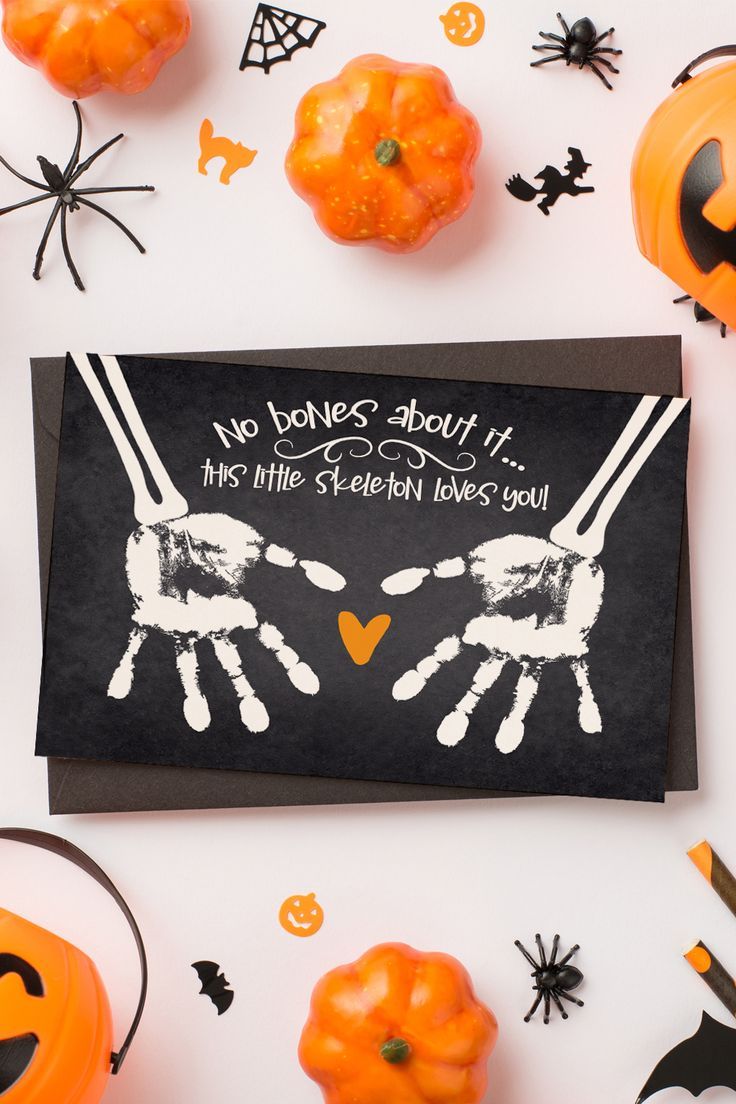 halloween greeting card with handprinted hands and pumpkins