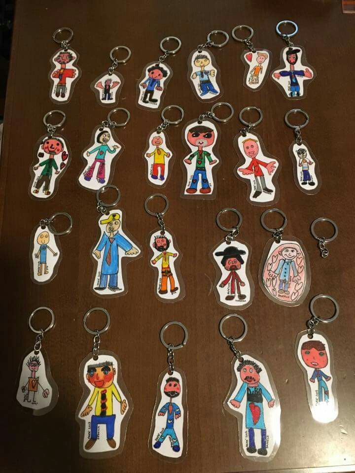 several key chains with cartoon characters on them sitting on top of a wooden table next to each other