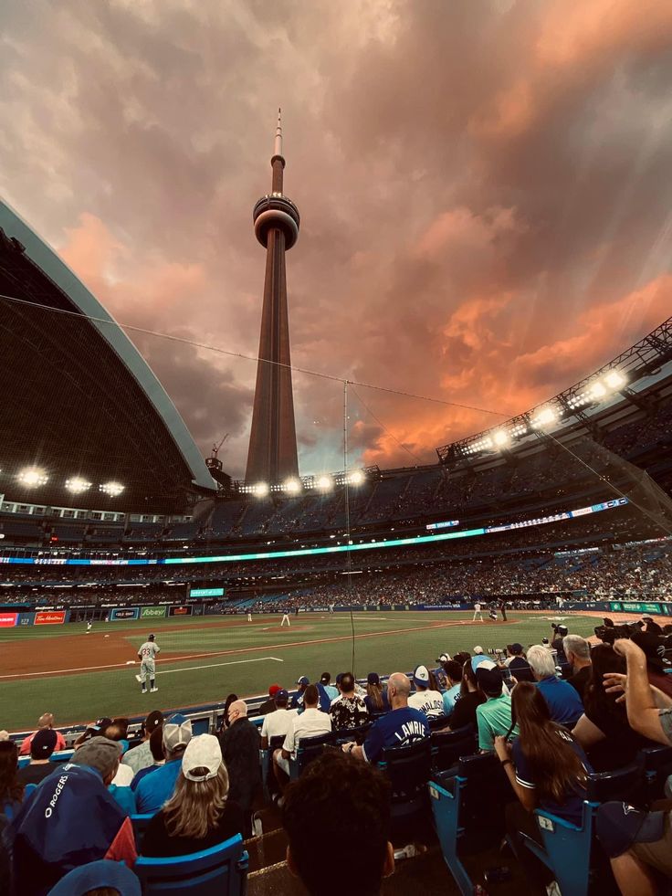 a baseball game in progress with the sun going down