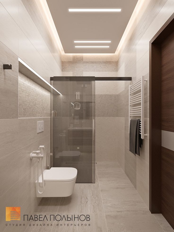 a bathroom with a toilet, sink and shower in it's center wall is illuminated by recessed lighting