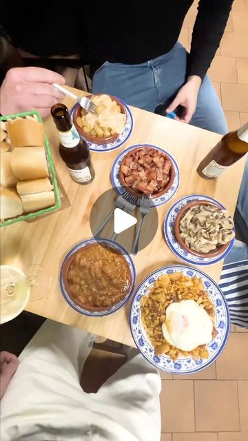 people sitting at a table with plates of food